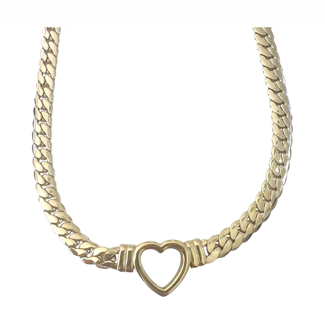 Photograph of a polished gold flat cuban chain necklace featuring a central open heart pendant connected by ribbed barrel elements