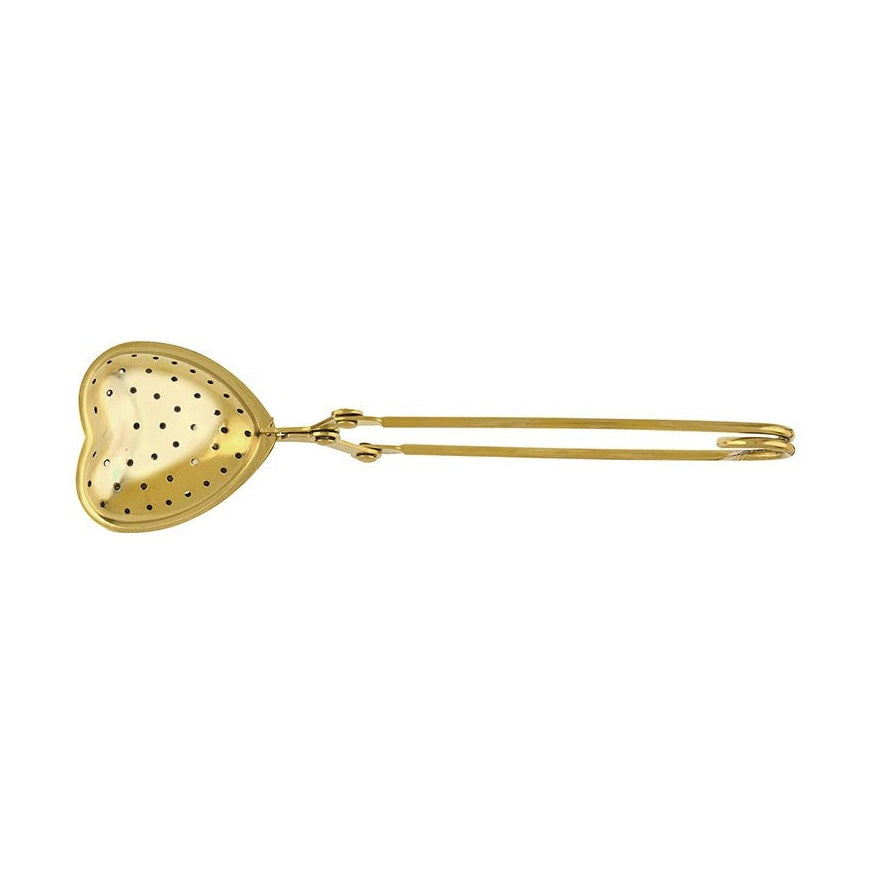A metallic golden heart-shaped tea infuser with a perforated design and a long hinged handle