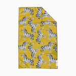 Crae textile towel with a lively repeating pattern of black and white zebras in various dynamic poses on a rich mustard yellow background