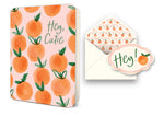 Greeting card with orange pattern and text Hey Cutie next to an envelope with orange liner and Hey sticker