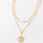 Gold layered paperclip chain necklace with a circular letter M pendant
