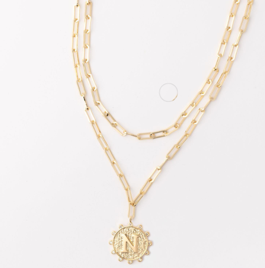 Gold layered paperclip chain necklace with a circular pendant featuring the letter N