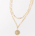 Gold layered paperclip chain necklace with a circular pendant featuring the letter R