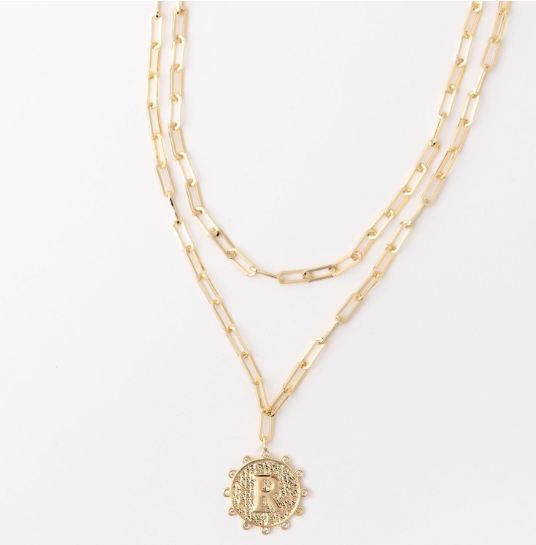 Gold layered paperclip chain necklace with a circular pendant featuring the letter R