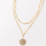 Gold layered paperclip chain necklace with a textured coin pendant featuring the letter T