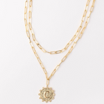 Gold layered paperclip chain necklace with a circular pendant featuring the letter C