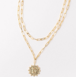 Gold layered paperclip chain necklace with a circular letter D pendant