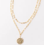 Gold layered paperclip chain necklace with a circular letter G pendant