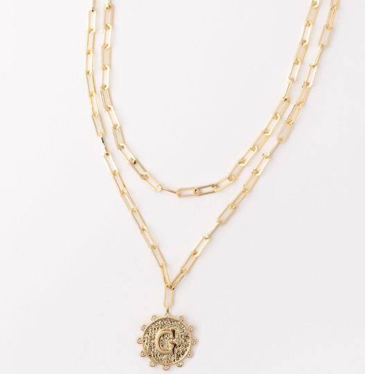 Gold layered paperclip chain necklace with a circular letter G pendant