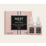 Product photography by NEST New York of Himalayan Salt and Rosewater smart home fragrance refills featuring a dusty pink box with white scalloped patterns and two matching square bottles with black labels and white caps