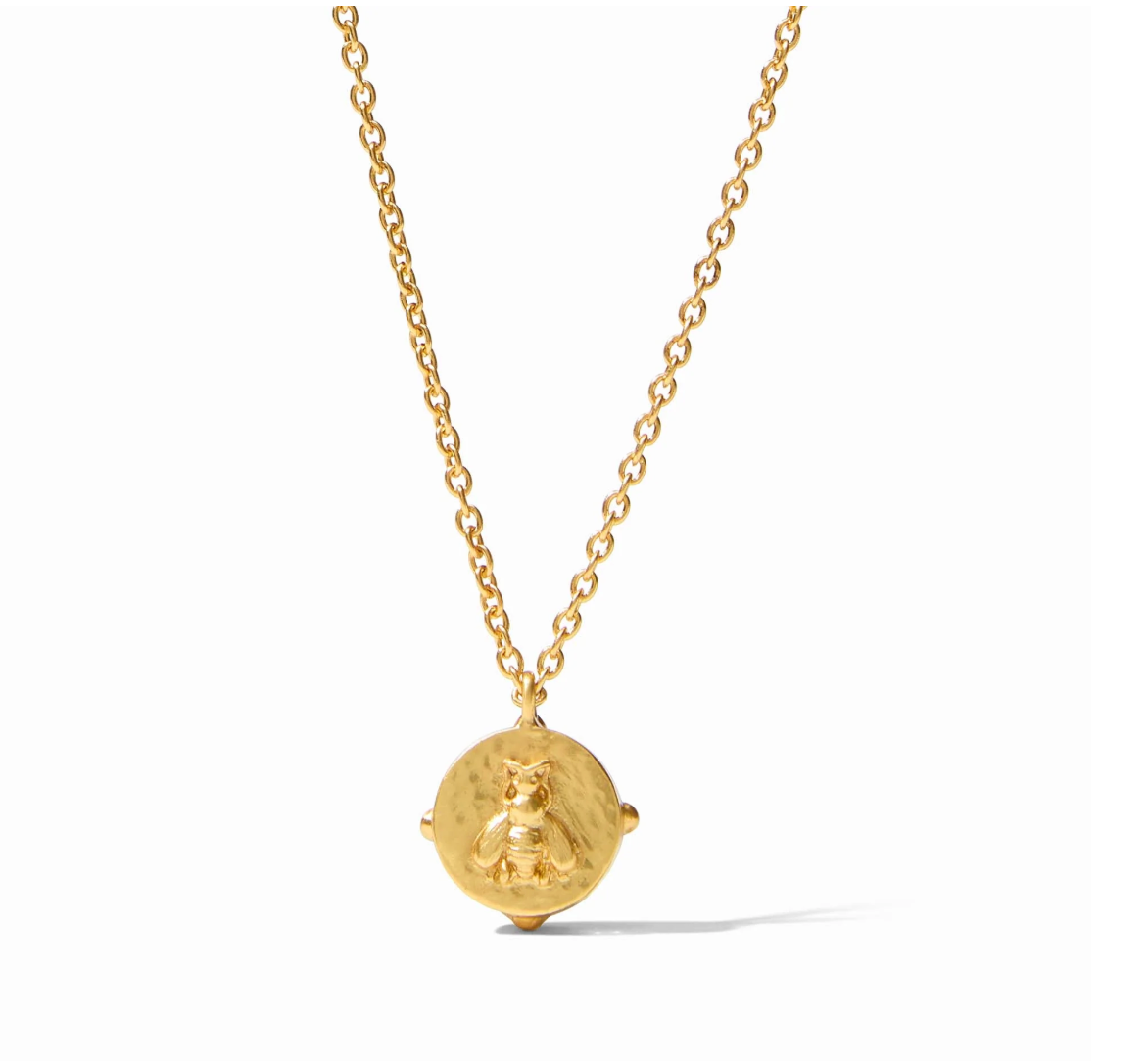 Gold necklace with a round coin pendant featuring a bee motif