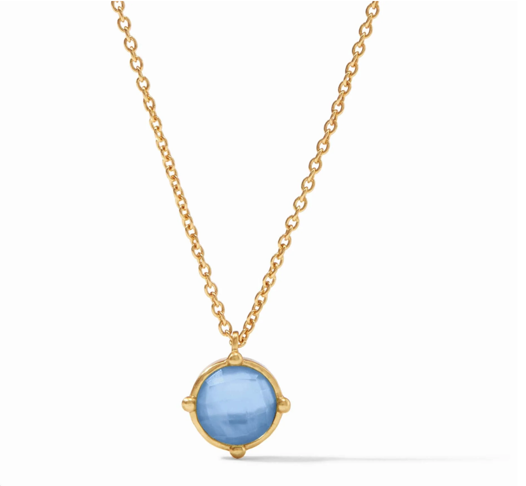 Gold chain necklace with a round blue stone pendant