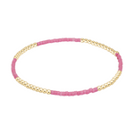 Stretch bracelet with alternating sections of gold beads and small pink beads