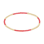 Stretch bracelet with alternating sections of gold beads and small red cylindrical beads