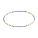 Stretch bracelet with alternating sections of gold beads and light blue seed beads