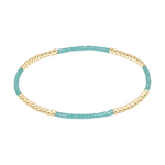 Stretch bracelet with alternating sections of gold beads and turquoise seed beads