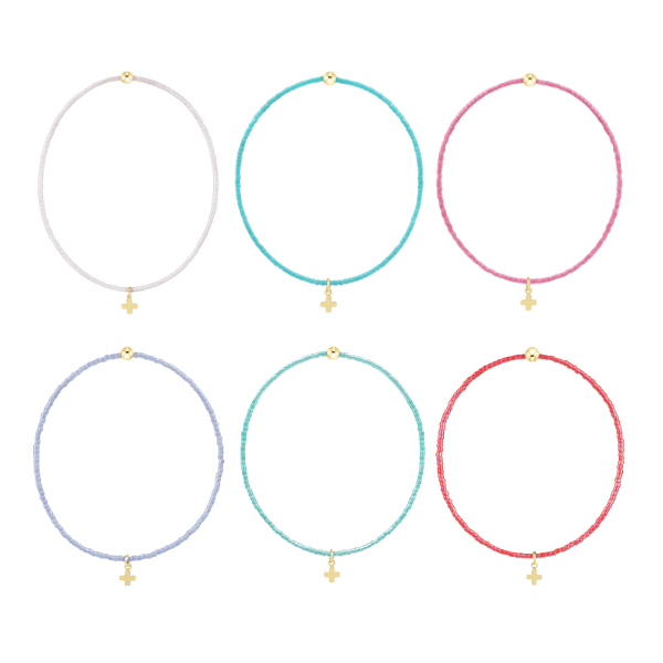 Product photography of six colorful seed bead bracelets featuring delicate gold cross charms and polished gold accent beads in vibrant shades of turquoise, lavender, and hot pink arranged in a grid on a white background