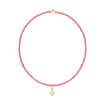 Pink beaded bracelet with a gold cross charm and a single gold bead