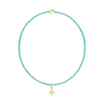 Light blue beaded bracelet with a gold cross charm and a single gold bead
