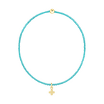 Turquoise beaded bracelet with a gold cross charm and a single gold bead