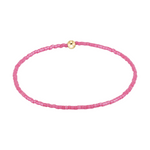 Pink beaded stretch bracelet with a single gold bead