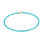 Turquoise beaded stretch bracelet with a single gold bead
