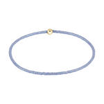 Stretch bracelet with light blue seed beads and a single gold bead