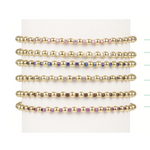 Stack of six gold bead bracelets with alternating colored accent beads