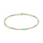 Gold bead bracelet featuring small polished gold beads interspersed with bright turquoise enamel beads and a single larger gold accent bead