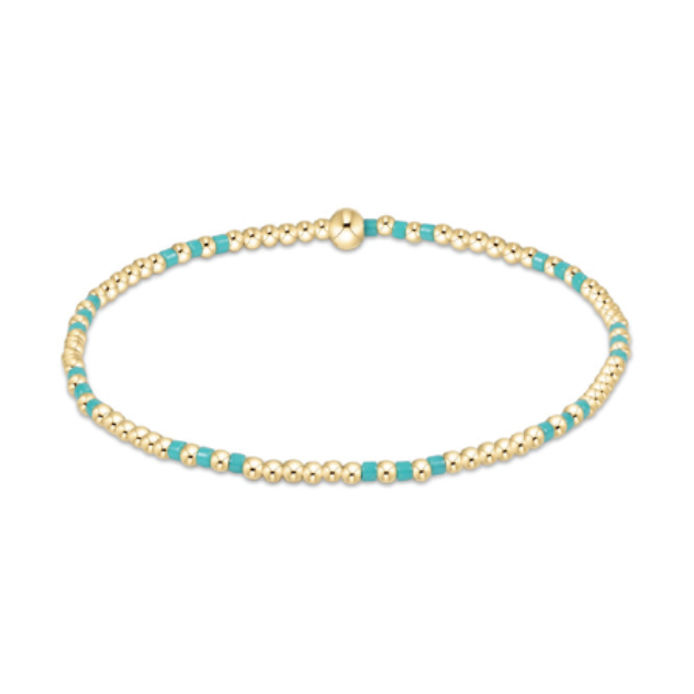 Gold bead bracelet featuring small polished gold beads interspersed with bright turquoise enamel beads and a single larger gold accent bead
