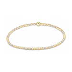 A delicate beaded bracelet featuring alternating tiny round gold beads and small flat light grey beads with a single larger gold bead as a focal point on a plain white background