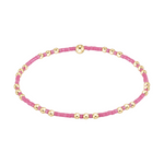 Stretch bracelet with pink seed beads and gold tone metal spheres