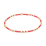 Stretch bracelet with alternating red glass beads and gold metal spheres