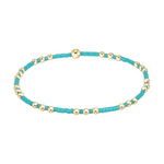 Stretch bracelet with alternating turquoise seed beads and small gold spheres