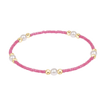 Pink beaded bracelet with gold and pearl accents