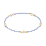 Light blue beaded bracelet with gold beads and white pearls