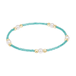 Turquoise seed bead bracelet with gold tone spacers and white pearls