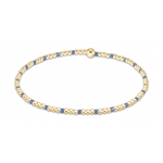 Gold and blue beaded bracelet featuring a delicate alternating pattern and a single prominent gold bead