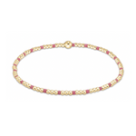 A delicate bracelet featuring alternating tiny spherical gold beads and short rectangular fuchsia pink beads, secured with a larger spherical gold clasp, isolated on a white background