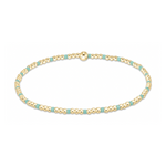 A thin gold beaded bracelet with intermittent small rectangular teal beads and a larger spherical gold bead