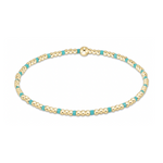 A minimalist beaded bracelet featuring small gold spheres alternating with vibrant turquoise beads and a larger gold spherical bead