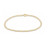 Jewelry a minimalist stretch bracelet featuring small round gold beads alternating with light grey segments and a prominent central gold bead accent