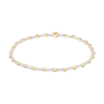 Stretch bracelet with alternating gold tone metal beads and small white glass seed beads