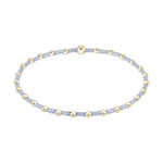 Stretch bracelet with light blue seed beads and gold tone metal spacer beads