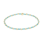 Stretch bracelet with alternating light blue seed beads and gold metallic spheres