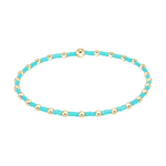 Stretch bracelet with alternating gold beads and small turquoise seed beads