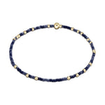 Jewelry bracelet delicate thin beaded bracelet featuring dark and light blue square beads interspersed with small round gold beads