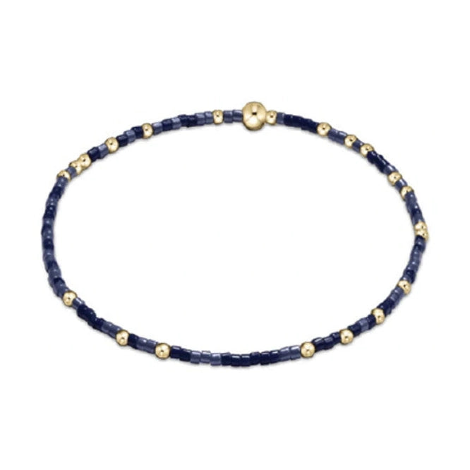 Jewelry bracelet delicate thin beaded bracelet featuring dark and light blue square beads interspersed with small round gold beads