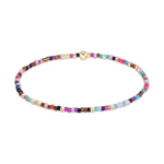 A delicate seed bead bracelet with a gold spherical clasp and small gold spacer beads featuring a vibrant mix of pink, purple, blue, and bronze hues
