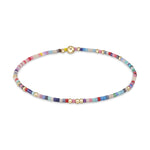 A vibrant, flat disc beaded bracelet featuring a mix of pastel and bright colors interspersed with small gold accent beads and a prominent gold clasp